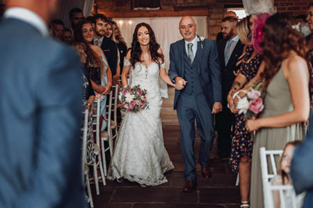 Amy and Stephen walk down the aisle