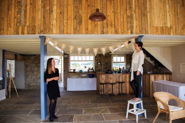 Wedding coordinator Sam working with Olivia in the barn