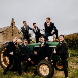 Guys in suits trying to look cool on a tractor