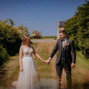 Couple holding hands on green lane