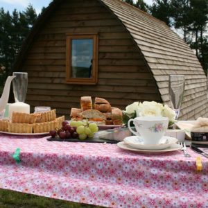 Glamping hut with food table laid out before it